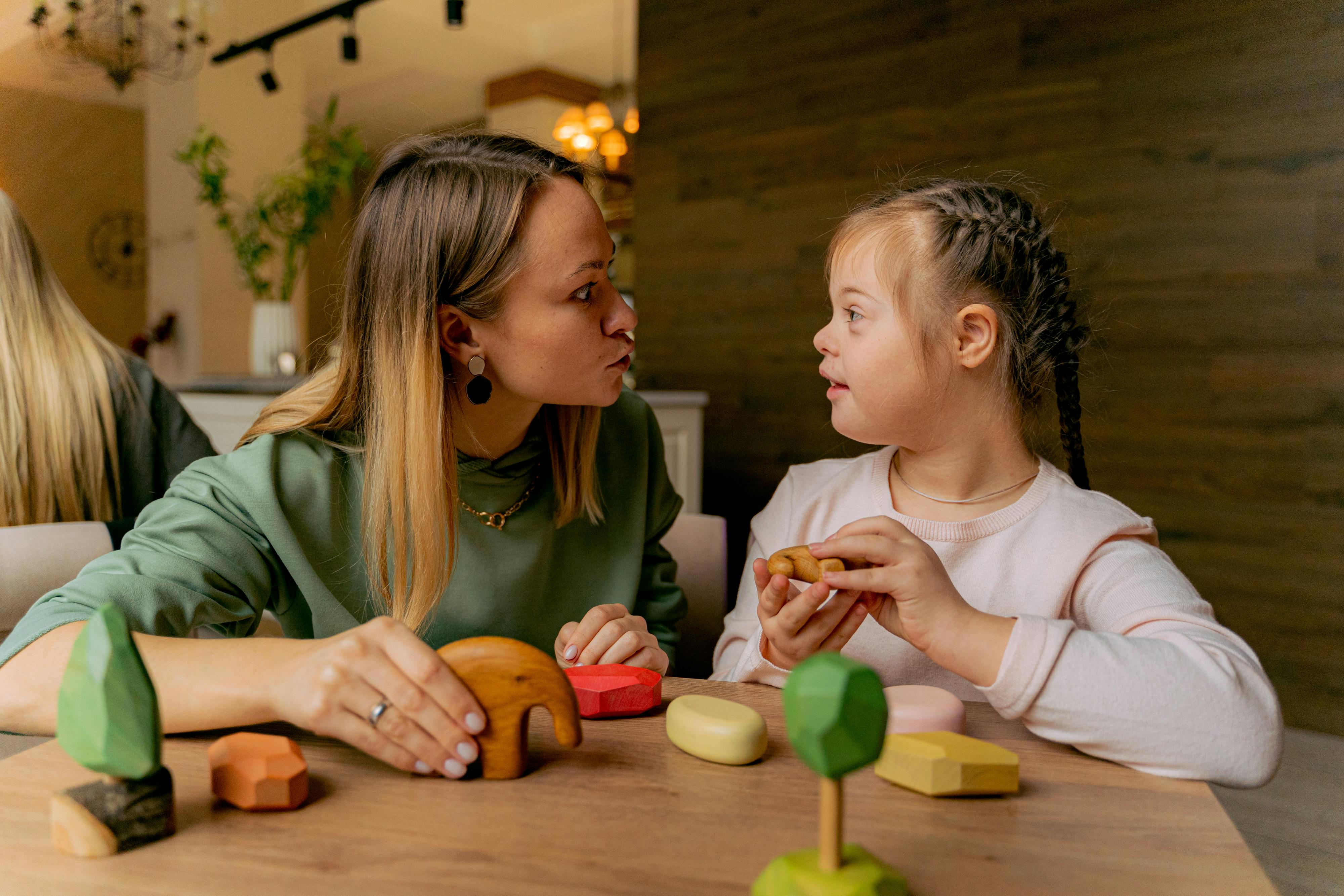 Young child with support engaged in sensory play